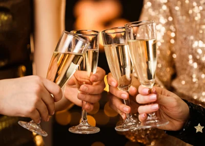 A champagne toast with four people at formal event.