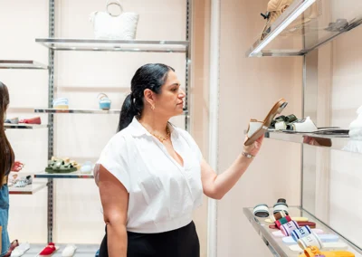 Woman in boutique shopping for shoes.