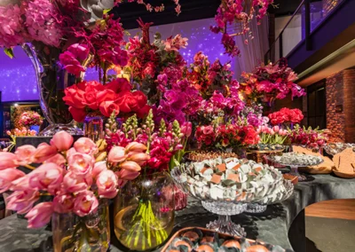 Floral arrangements and food presentation at formal event.