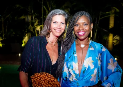 Two women smiling at the camera.