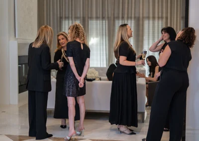 Group of women standing and talking in grand lobby.